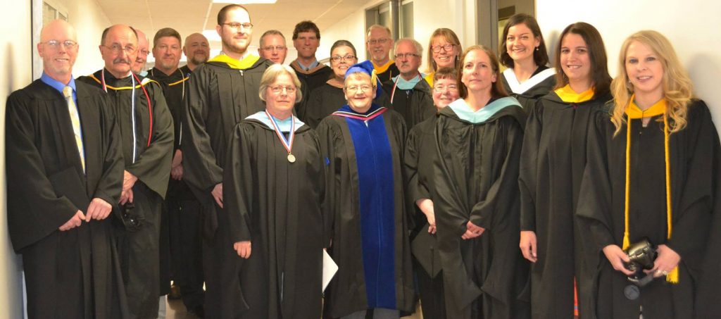 Faculty members in graduation gowns